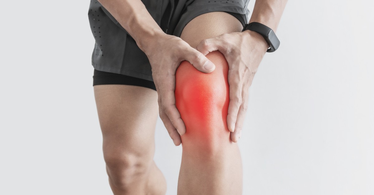 person holding their knee in pain