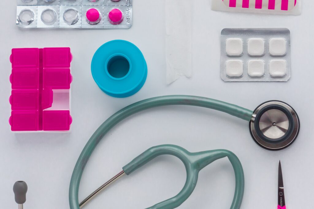 white backdrop with a stethoscope and medical items