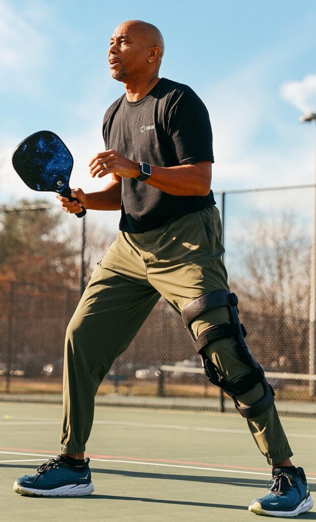 Man playing pickleball with an Icarus knee brace