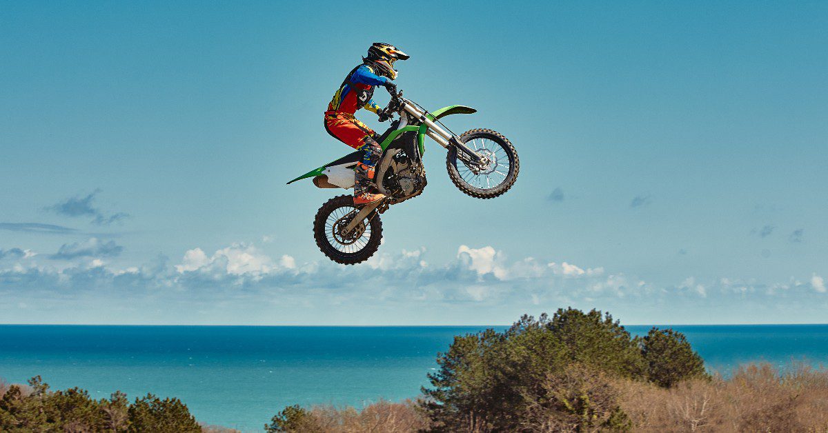motocross rider jumping over a valley