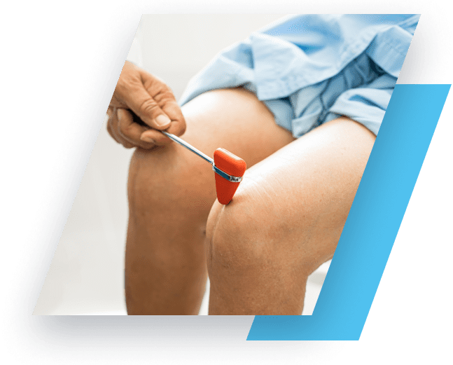 person having their knee tapped by a doctor