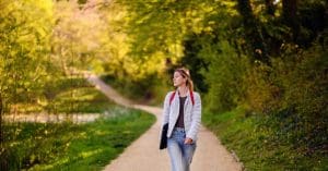 woman walking down a trail
