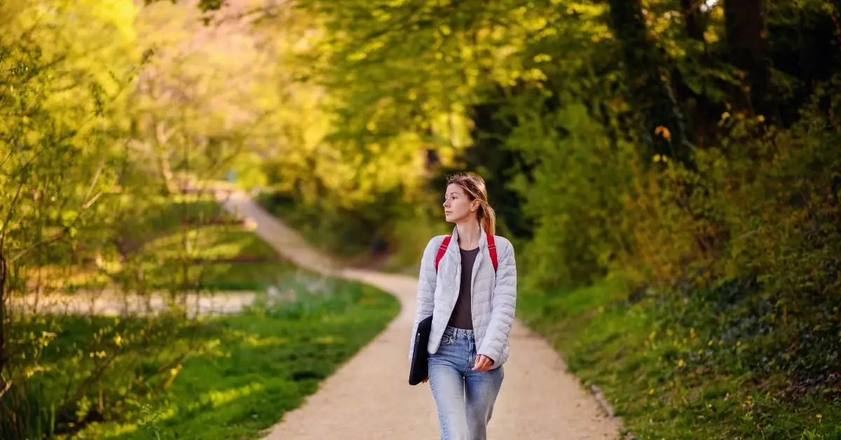 woman walking down a trail