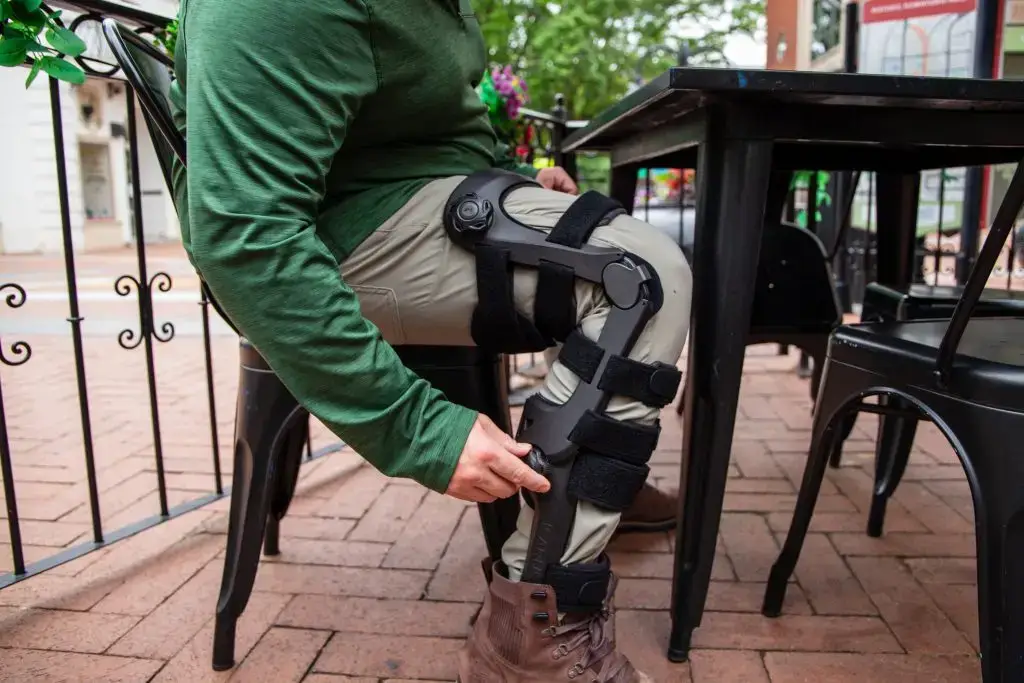 man sitting at a table demonstrating the zeus afo