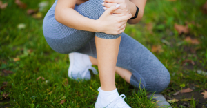 woman holding her knee