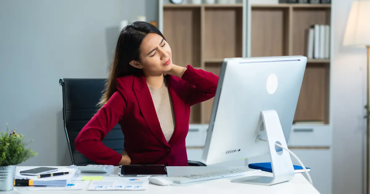 woman in pain at desk