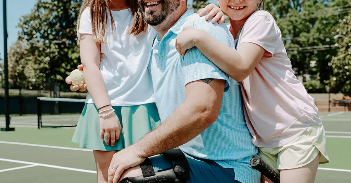father in a knee brace with his children