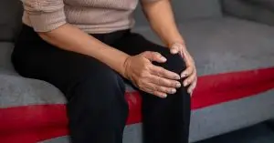 woman holding her knee