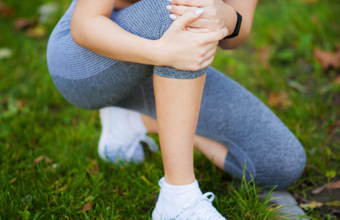 woman holding her knee