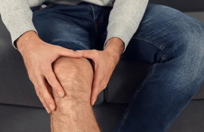 man holding his knee