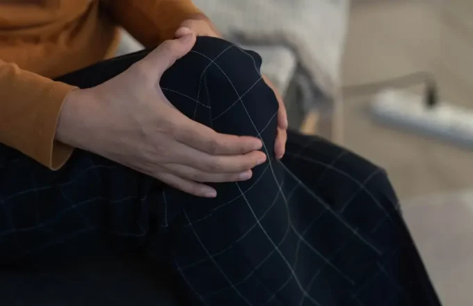 woman holding her knee